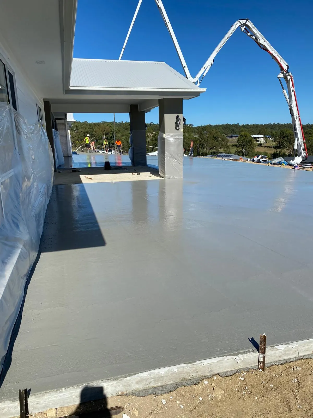 Boom pump placing a house slab